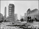Horse-drawn wagons travel past the rubble of stone buildings on Market Street. Horse-drawn wagons travel past the rubble of stone buildings on Market Street.