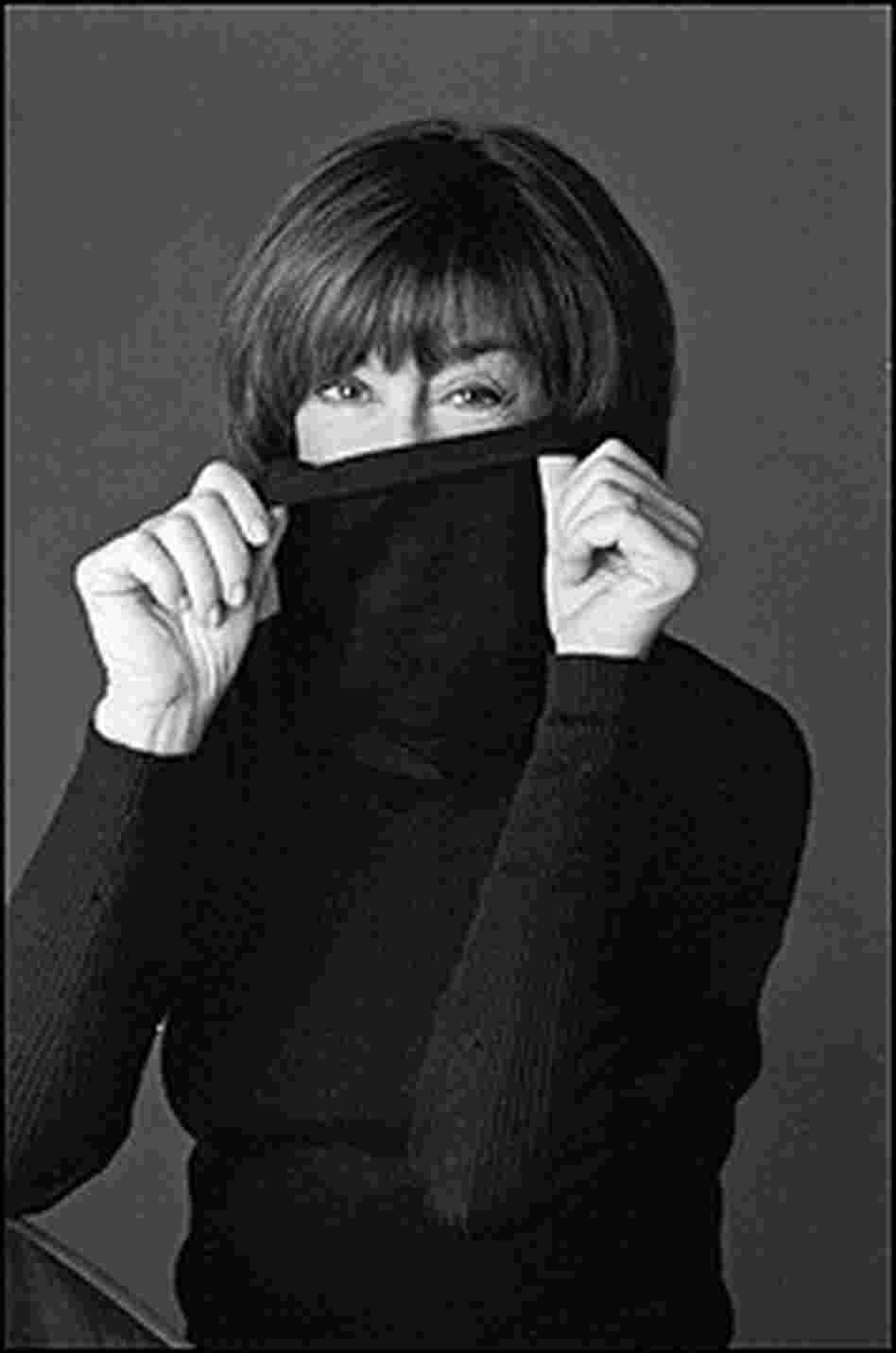 Photo of Nora Ephron hiding her neck inside a black turtleneck sweater.
