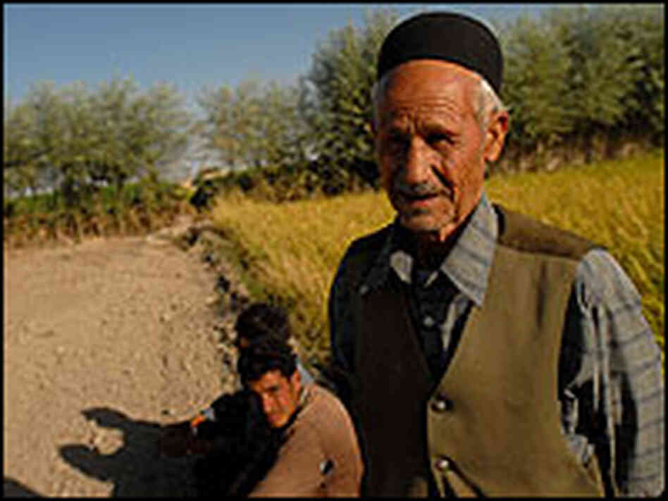 Village elder Jaafar Hosseini with workers near a rice field outside of Isfahan