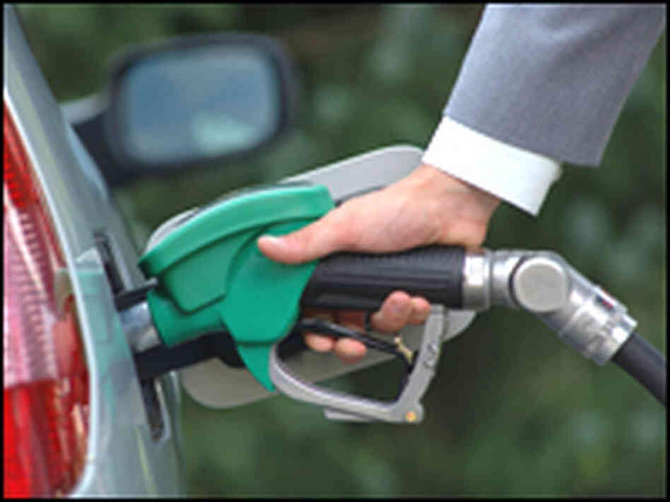 Hand pumping gas into car. Hand pumping gas into car.
