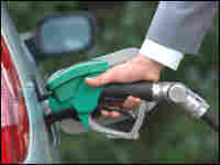 Hand pumping gas into car. Hand pumping gas into car.