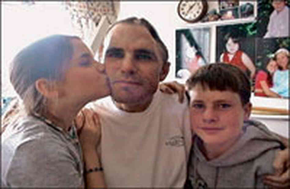 Woodruff sits with two of his children.