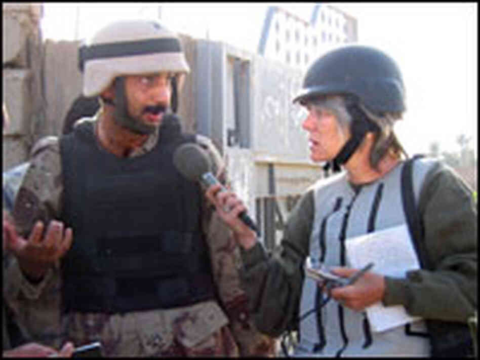 NPR correspondent Anne Garrels conducts an interview with an Iraqi soldier and interpreter.