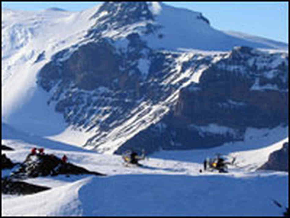 Researchers from the British Antarctic Survey arrive by helicopter to study a glacier.