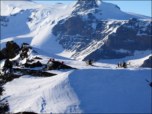 Researchers from the British Antarctic Survey arrive by helicopter to study a glacier.
