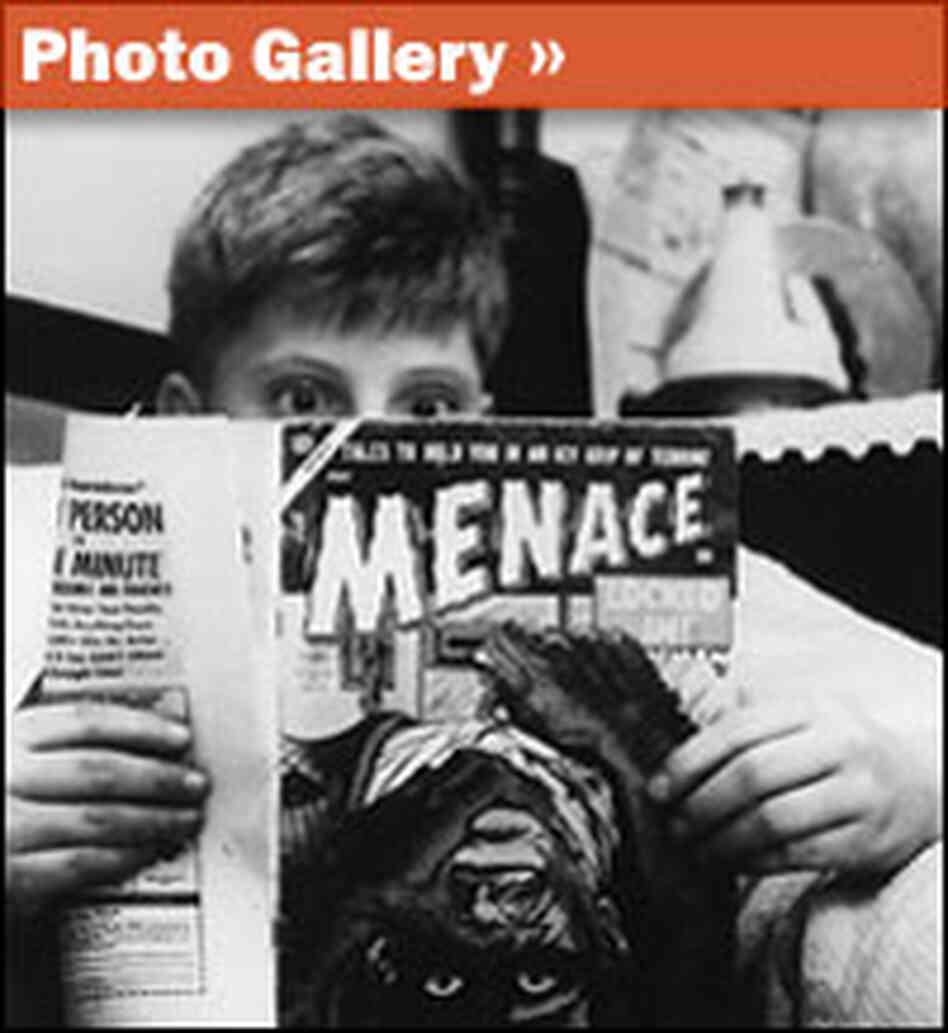 Boy reading comic book, looking shocked.