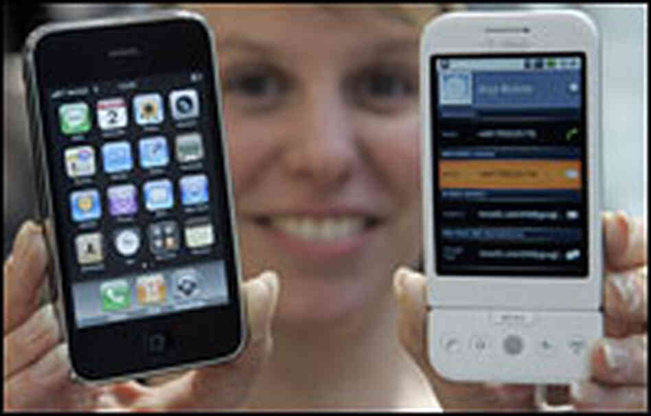 A woman shows two new mobile phones