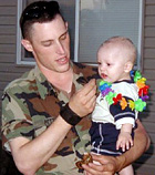 Jerrick Petty holding his son McKen.