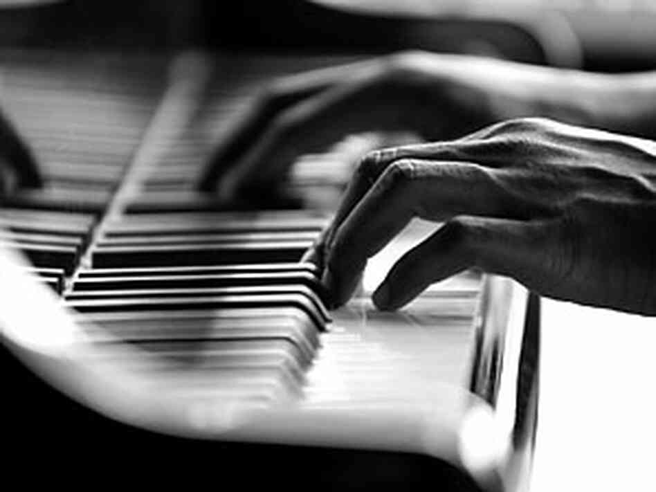 Hands playing on a piano. Hands playing on a piano.