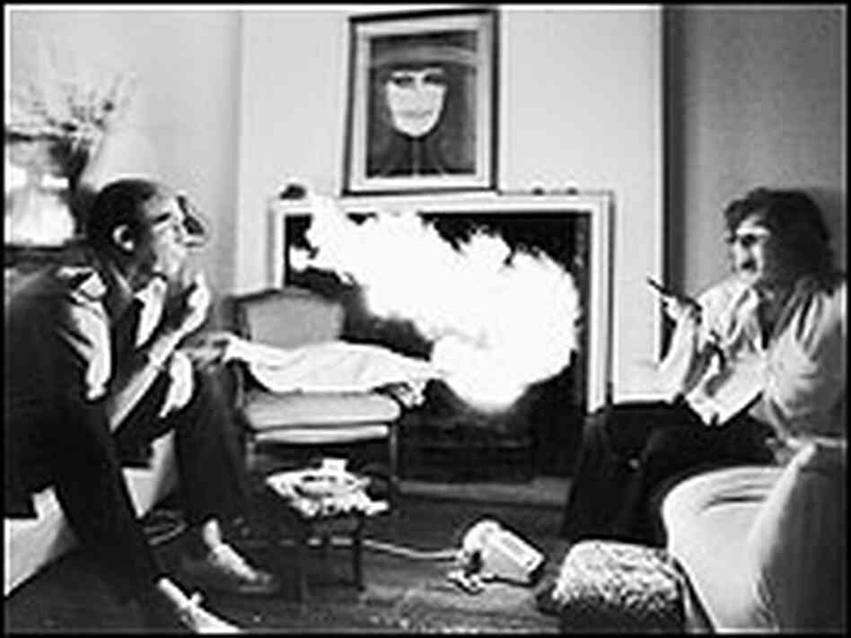 Thompson exhales a mouth full of lighter fluid at Jann Wenner.