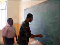 A member of the Awakening movement (right) practices reading in a classroom. A member of the Awakening movement (right) practices reading in a classroom.
