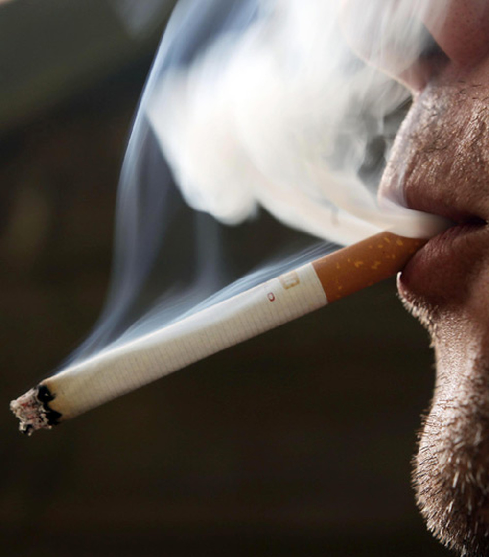 Smoking a cigarette. CREDIT: Owen Humphreys/PA Wire/AP