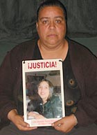Norma Andrade de Garcia holds a picture of her daughter, Alejandra