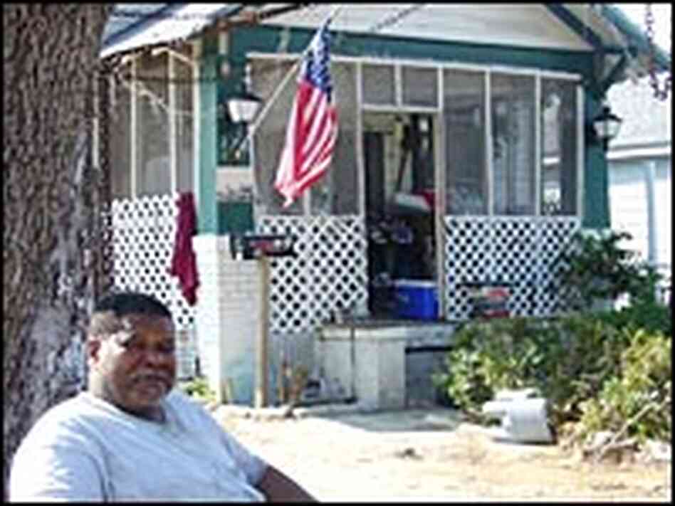 Atlas Brown sits in front of a friend's flood-damaged home in Biloxi, Miss. Atlas Brown sits in front of a friend's flood-damaged home in Biloxi, Miss.
