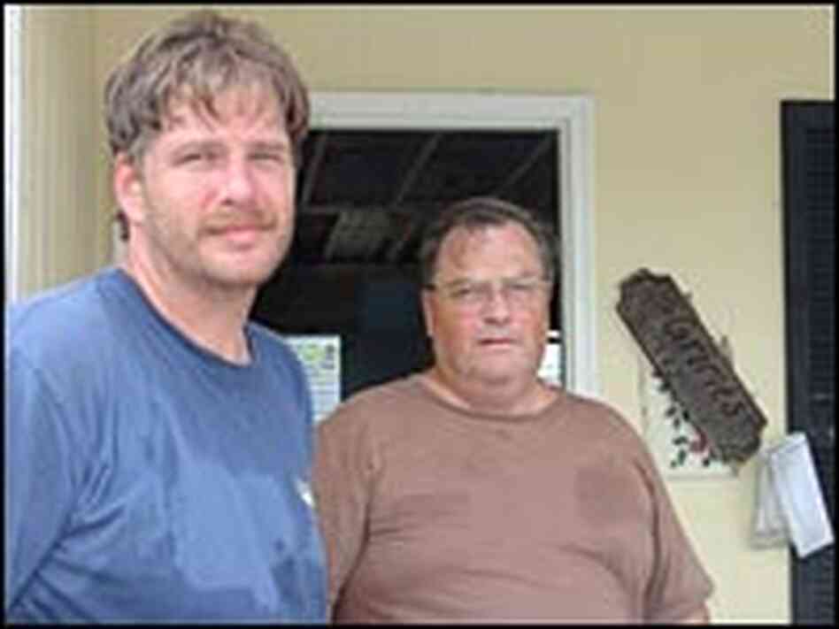 Jerry Grimes and son Jay at their damaged home. Jerry Grimes and son Jay at their damaged home.