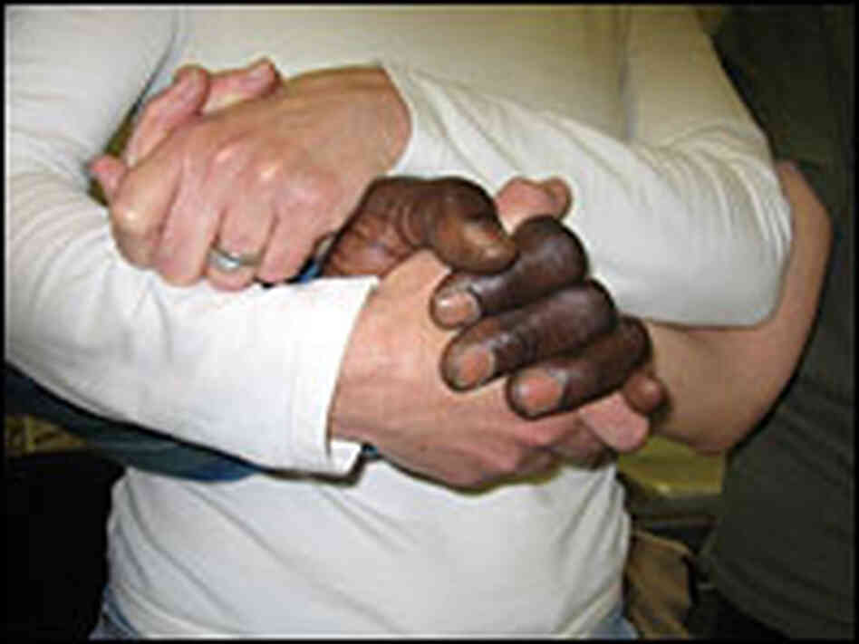 Members of Shades of Praise hold hands during the prayer circle that closes their rehearsal. Members of Shades of Praise hold hands during the prayer circle that closes their rehearsal.