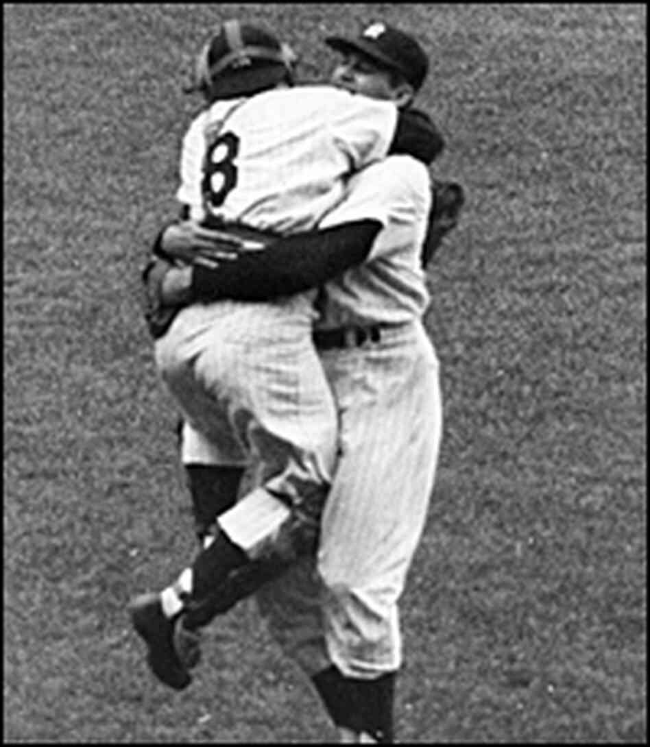 Yankee catcher Yogi Berra (left) hugs teammate Don Larsen