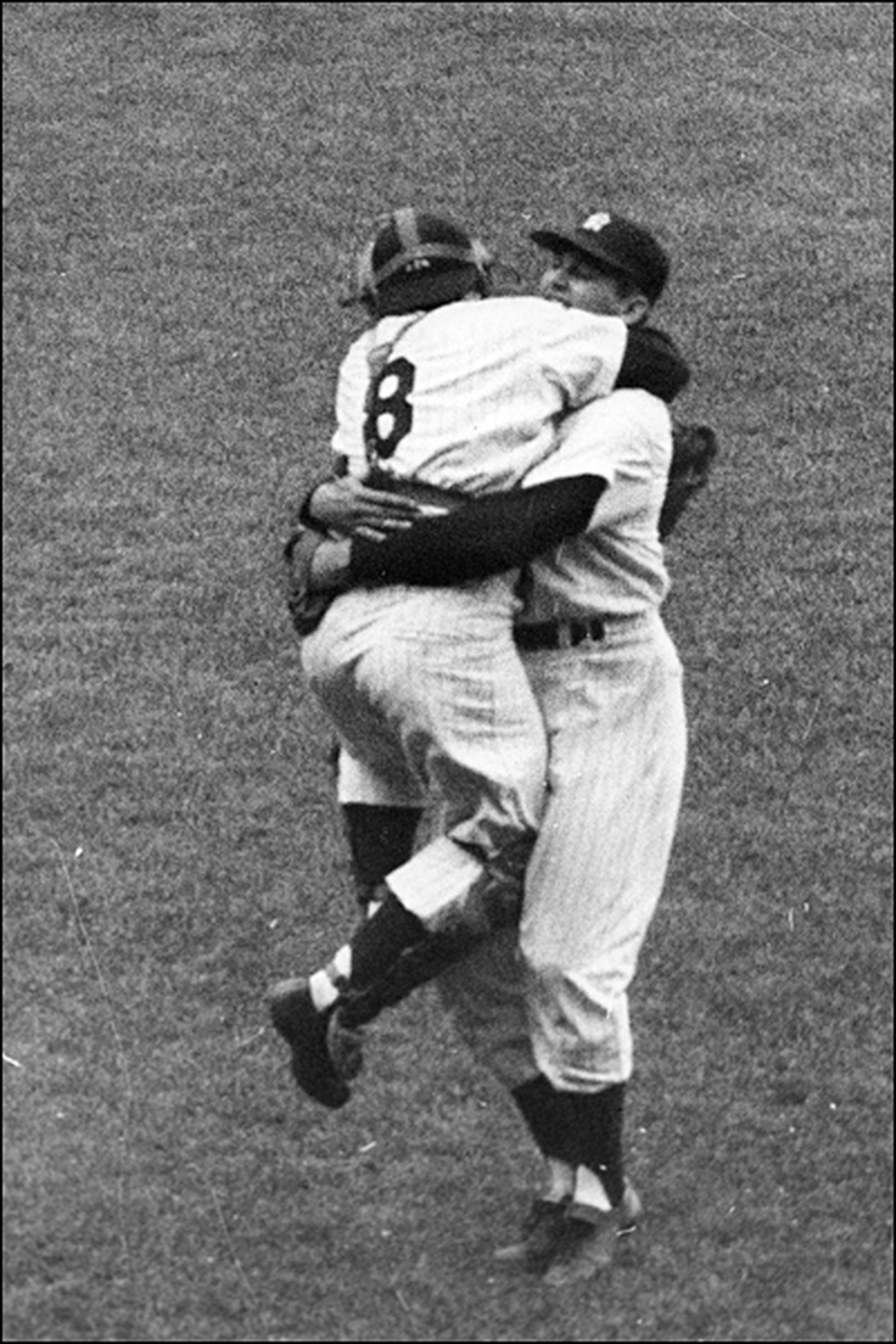Yankee catcher Yogi Berra (left) hugs teammate Don Larsen