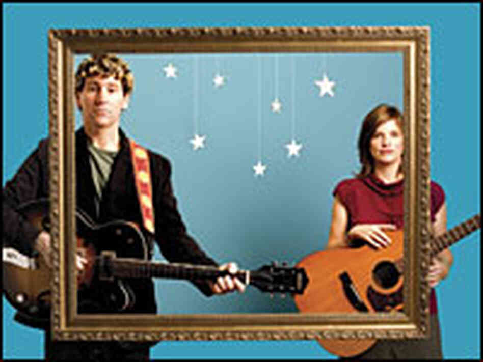 Steve Tannen and Deb Talan stand at the opposite boundaries of a photo frame.