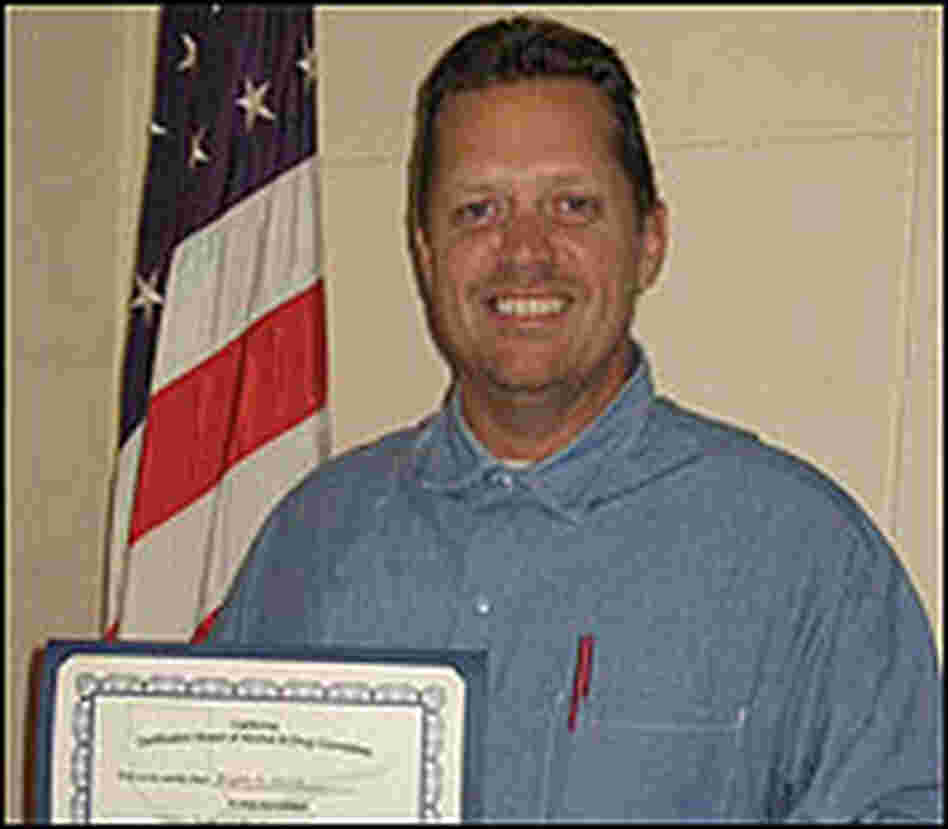 Brian Smith Holds His Certificate