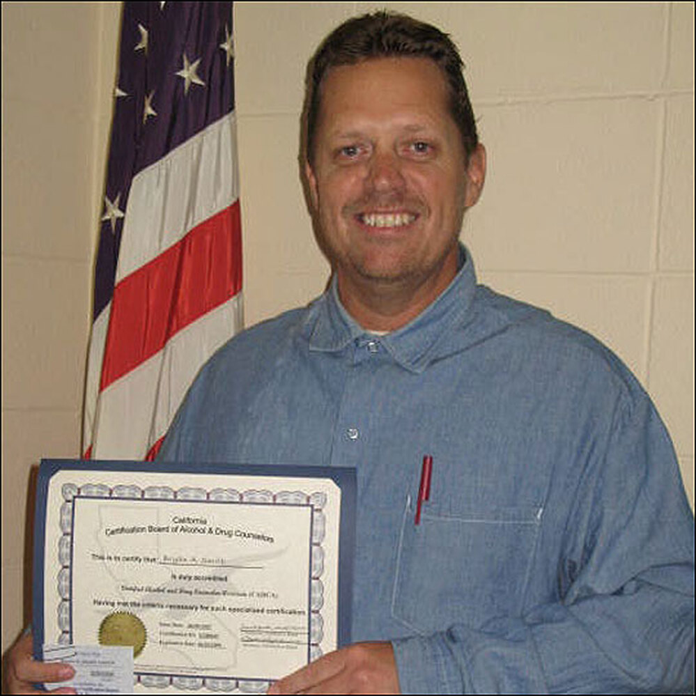 Brian Smith Holds His Certificate