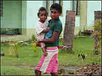 A boy carries a small child on the island of Viti Levu. A boy carries a small child on the island of Viti Levu.
