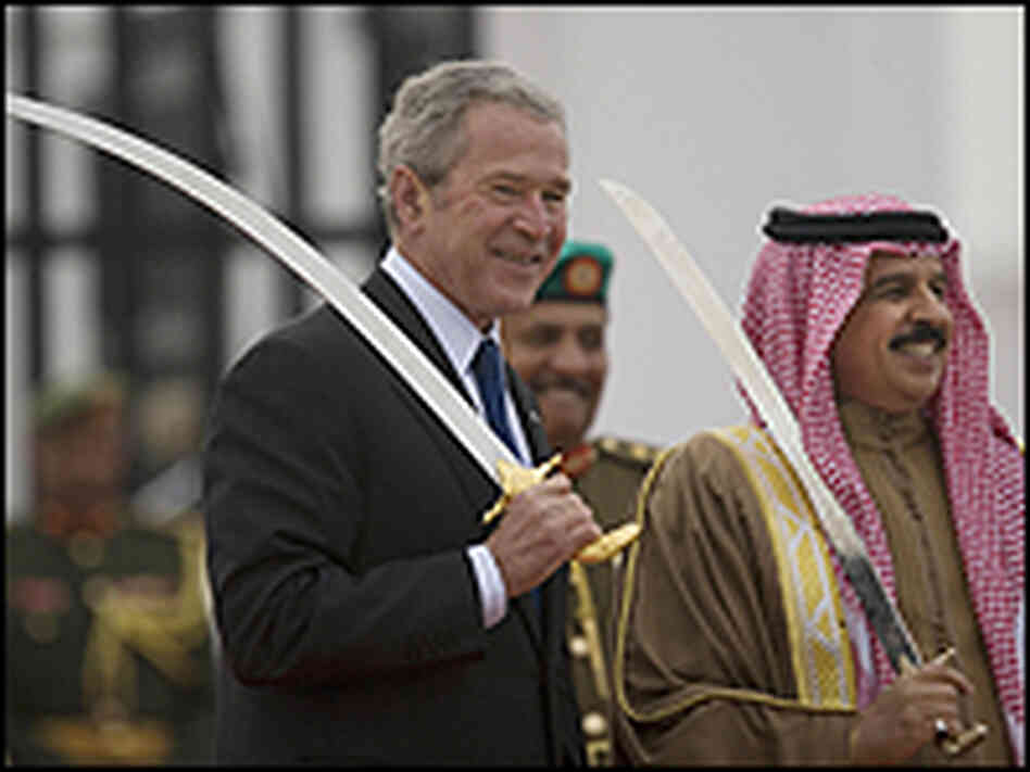 President George W. Bush holds up a sword as he poses for a picture with Bahrain's king. President George W. Bush holds up a sword as he poses for a picture with Bahrain's king.