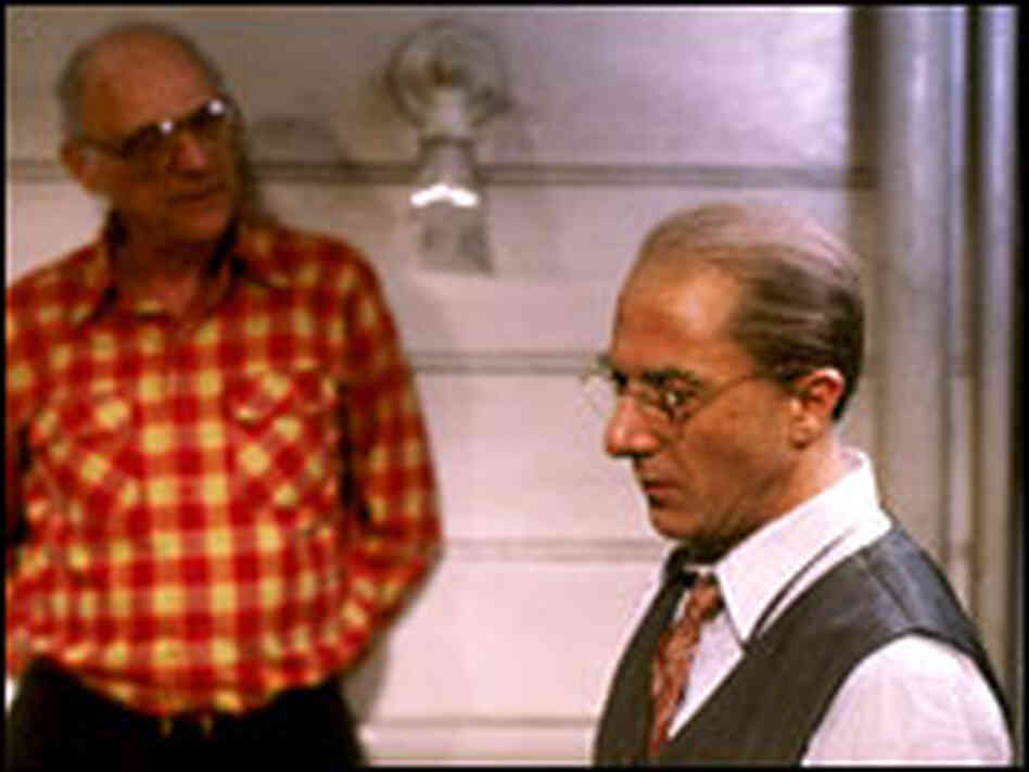 Arthur Miller leans against wall; Dustin Hoffman in character