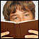 A young man peers over a book. Credit: iStockPhoto.com