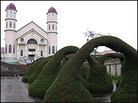 Topiary arches in front of church. Topiary arches in front of church.