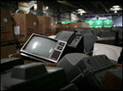 An analog television sits in a pile of TVs and monitors waiting to be dismantled at e-Recycling. An analog television sits in a pile of TVs and monitors waiting to be dismantled at e-Recycling.