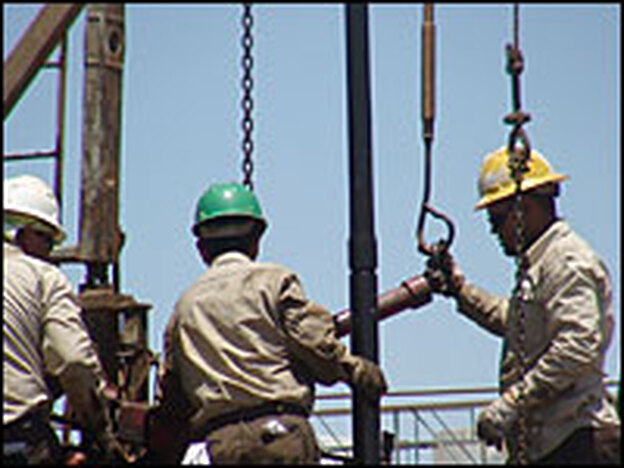 Oil workers operate a rig in Midland County, Texas, in June 2008. (AFP/Getty Images)