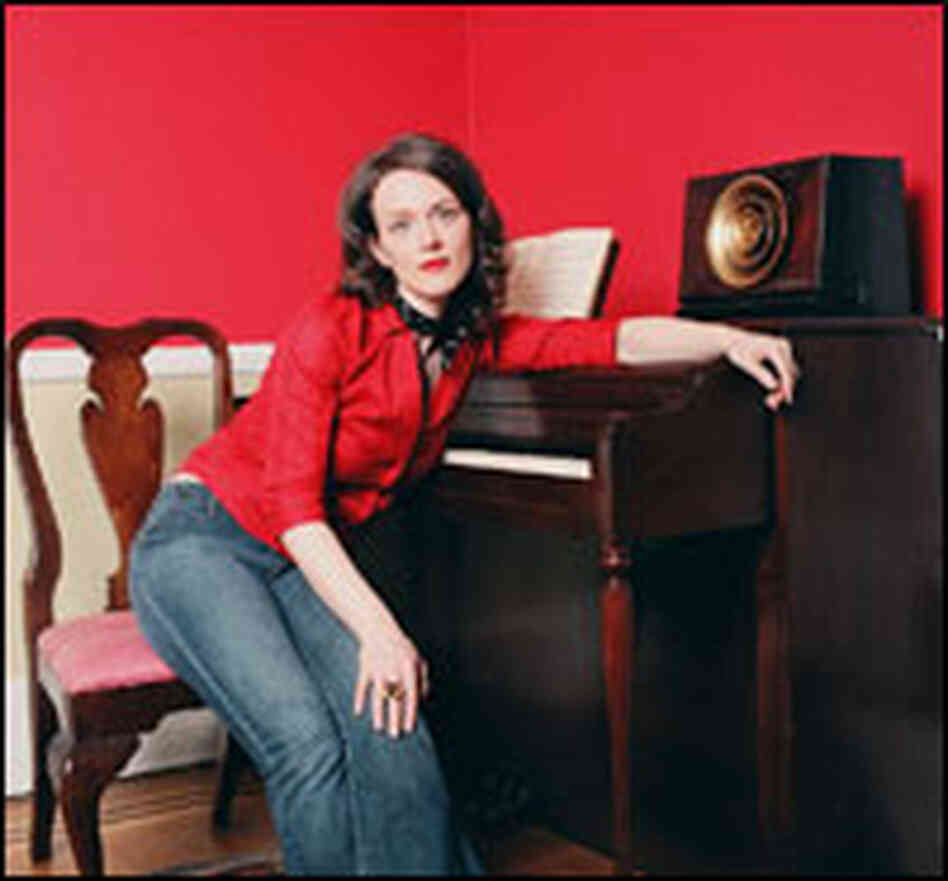 Laura Cantrell poses at a piano. Laura Cantrell poses at a piano.