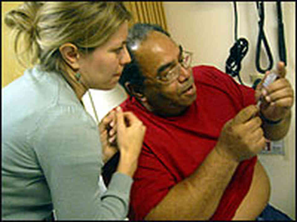 Dr. Jessie McCary helps Donald Cooper learn how to give himself an injection. Dr. Jessie McCary helps Donald Cooper learn how to give himself an injection.