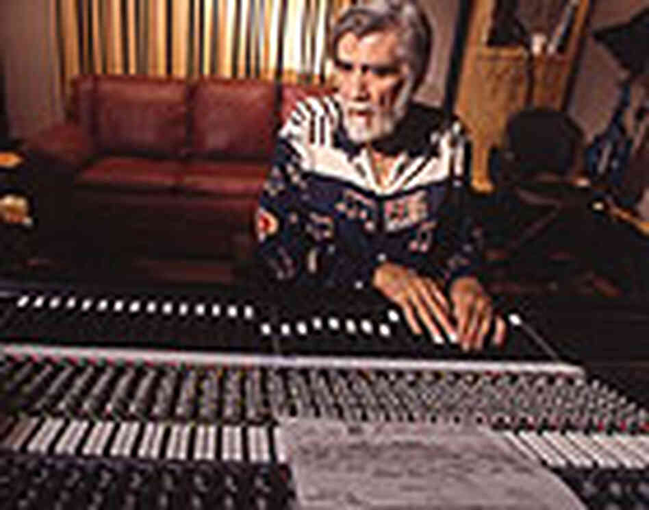 Tom Dowd at a mixing board with the sheet music for "Layla." Tom Dowd at a mixing board with the sheet music for "Layla."