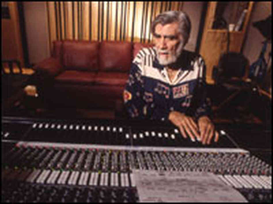Tom Dowd at a mixing board with the original sheet music for Eric Clapton's "Layla" Tom Dowd at a mixing board with the original sheet music for Eric Clapton's "Layla"