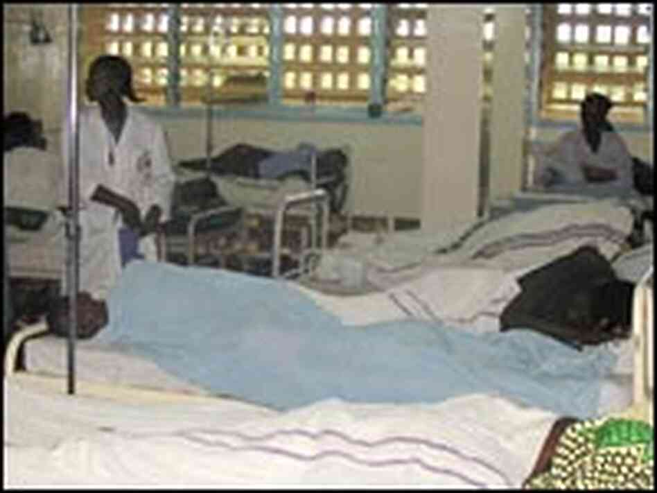 Two people share a bed at an overcrowded hospital in Kisumu, Kenya. Two people share a bed at an overcrowded hospital in Kisumu, Kenya.