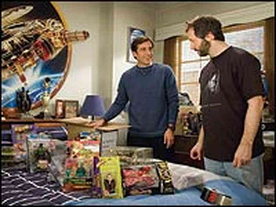 Steve Carell and Judd Apatow look over Star Wars figurines.