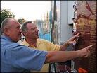 Two visitors inspect the names on the Rolling Memorial. Two visitors inspect the names on the Rolling Memorial.