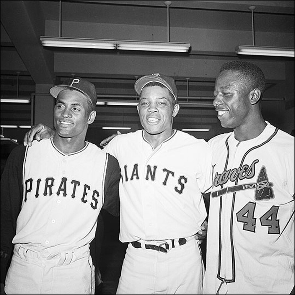 Roberto Clemente, Willie Mays and Henry Aaron pose in an All-Star Game locker room.
