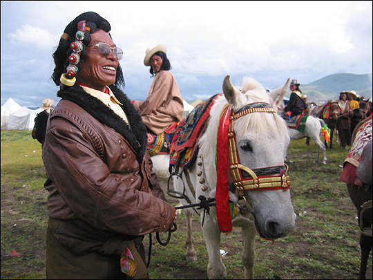 Silver, turquoise and coral jewelry adorn the hair of one participant in the festival.