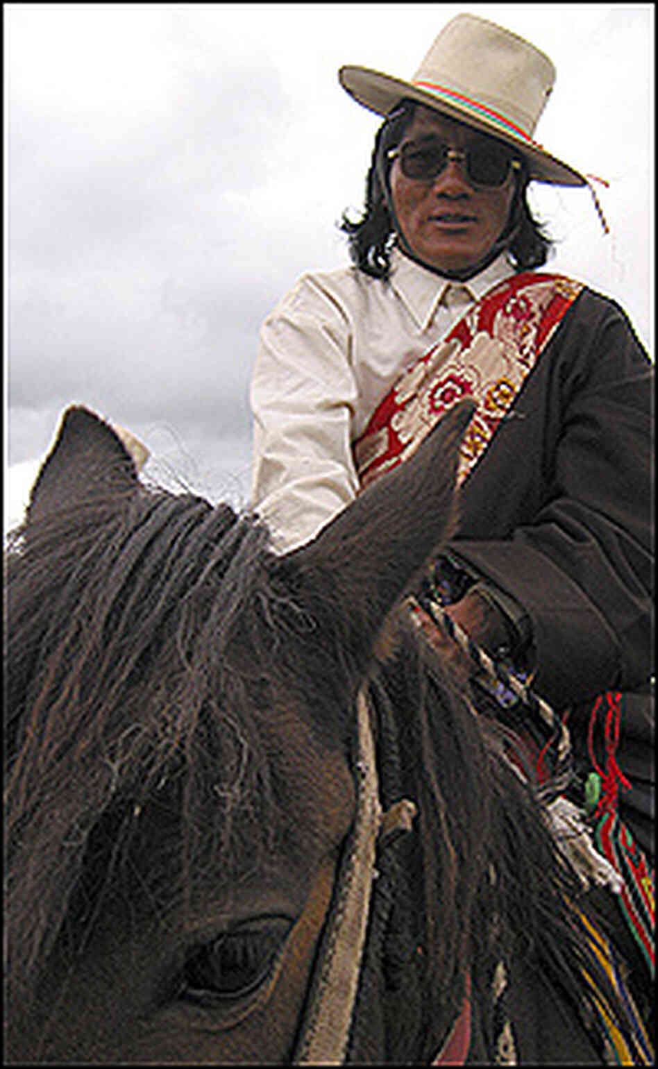 Typical attire for a Khampa horseman includes a western-style shirt under a Tibetan robe. Typical attire for a Khampa horseman includes a western-style shirt under a Tibetan robe.