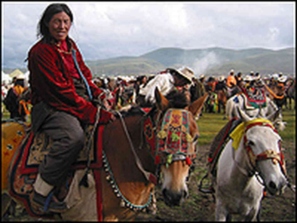 A Khampa horsemen saddles up for an initial charge opening the annual Litang Horse Festival.