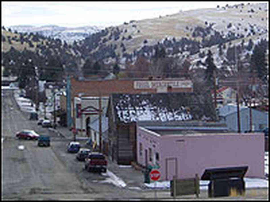 View of main street in Fossil, Oregon, with mountain backdrop.