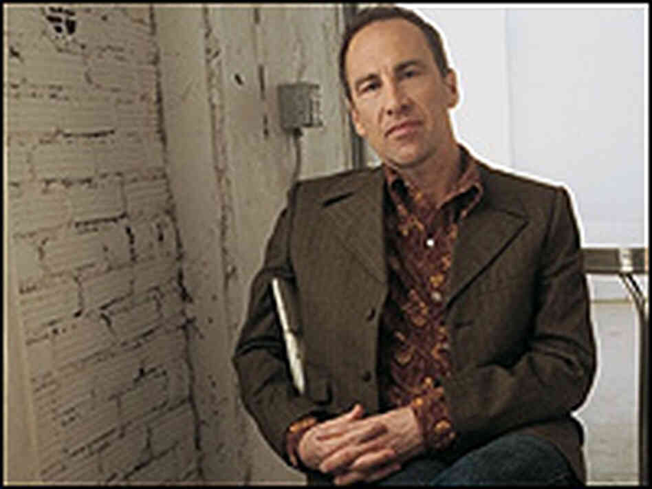 Tim O'Reagan, with close-cropped haircut, poses in a chair. Tim O'Reagan, with close-cropped haircut, poses in a chair.