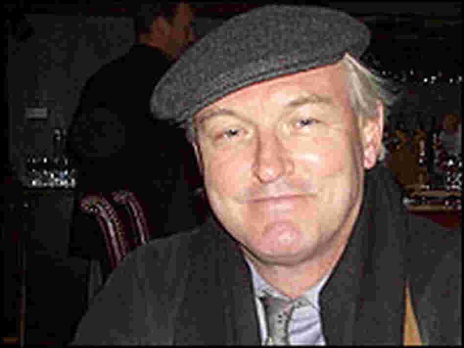Christopher Buckley, photographed wearing a cap inside a dark bar. Christopher Buckley, photographed wearing a cap inside a dark bar.
