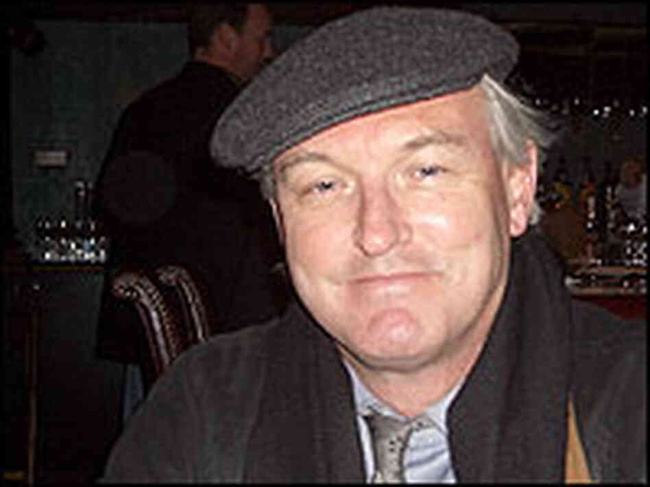 Christopher Buckley, photographed wearing a cap inside a dark bar. Christopher Buckley, photographed wearing a cap inside a dark bar.