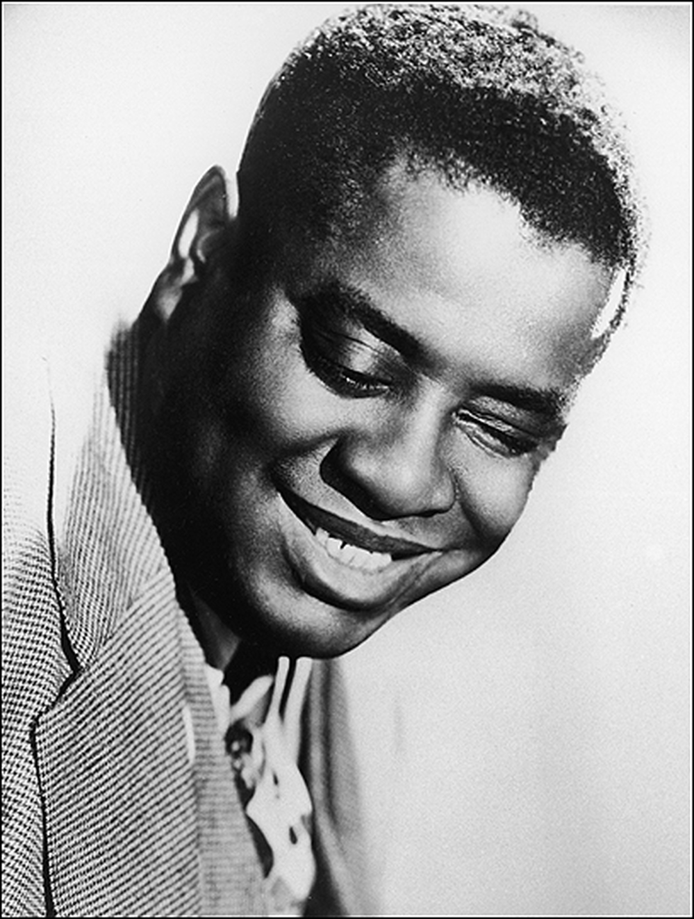 A closeup shot of a smiling Art Tatum.