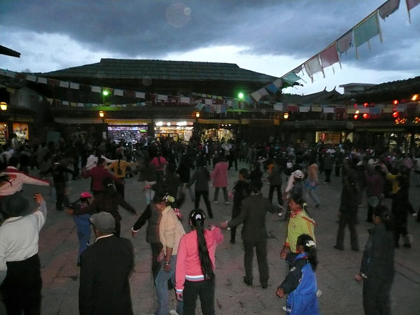 Local residents dance in the square of the old town.