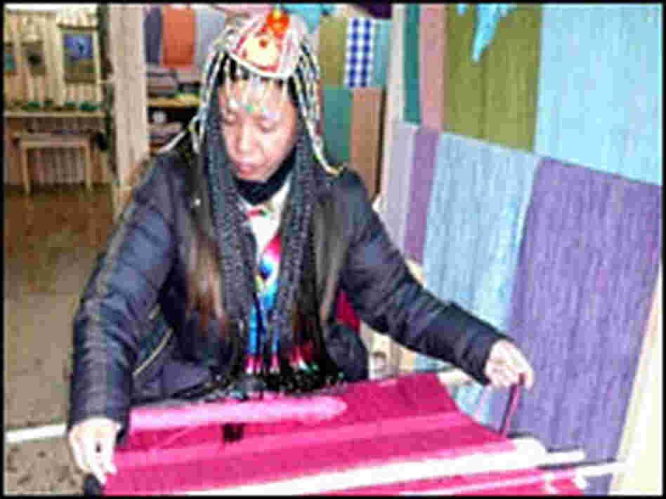 Tibetans sell scarves woven using traditional looms in the old town.